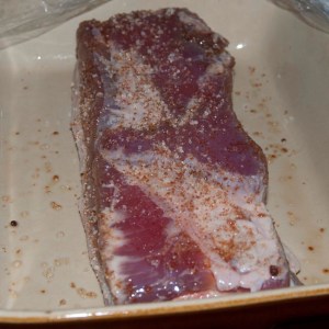 Streaky bacon mid-curing, with dry curing mix applied