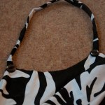 Strap with buttons in place