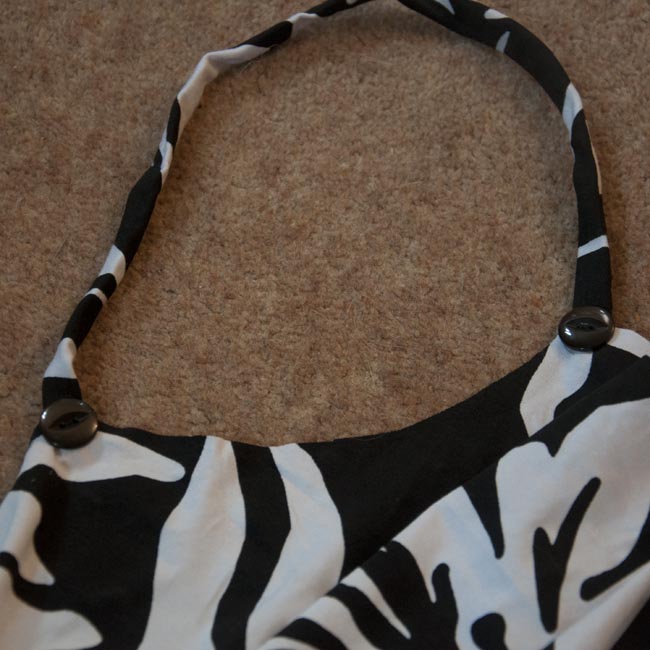 Strap with buttons in place