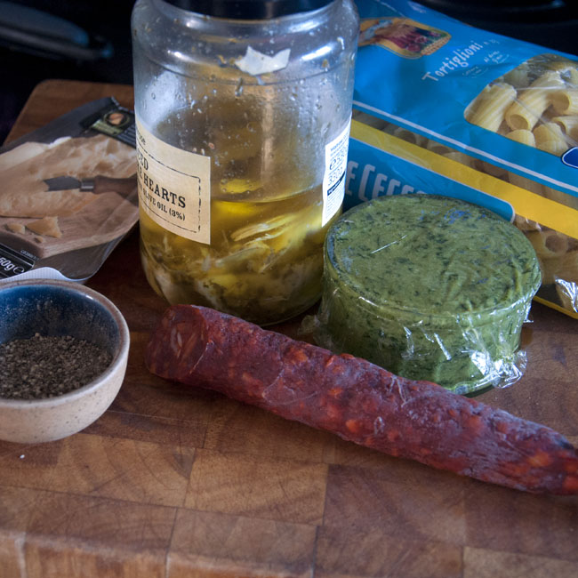 Pesto pasta with chorizo and artichokes