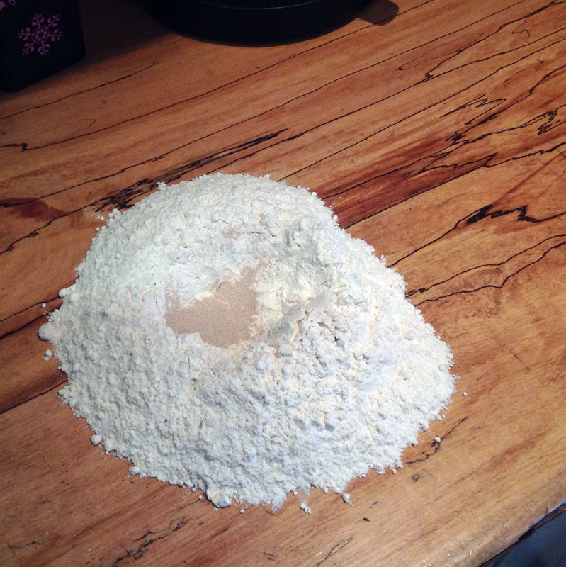 Make a well in the flour